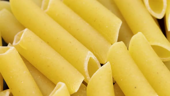 Italian macaroni penne, macro shot in 4k. Rotating motion, view from above. Close up shot.