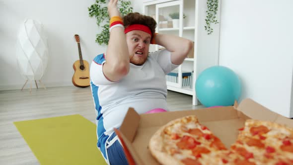Slow Motion of Chubby Sportsman Doing Pressups and Stretching Hands to Pizza Training Alone at Home