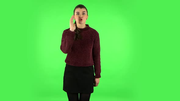 Annoyed Girl Screams Calling Someone on a Green Screen at Studio. Green Screen