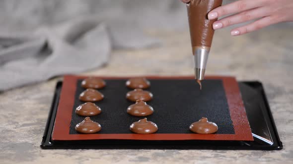 Cooking Chocolate Profiteroles, Female Hands Squeeze the Dough From the Bag Onto Baking Sheet