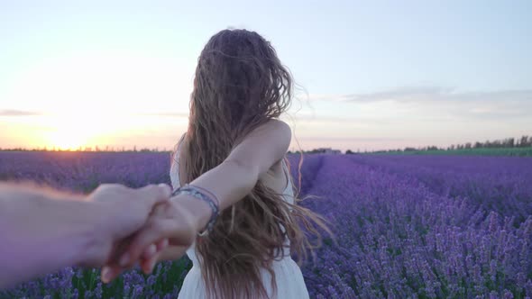 Girl with Boy's Hand Walks on the Lavender Field