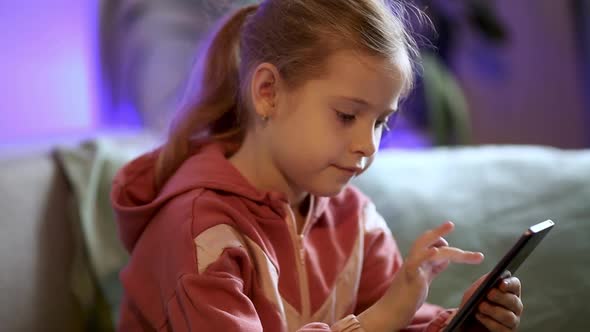 A Little Girl with a Smartphone in Her Hands Lifestyle
