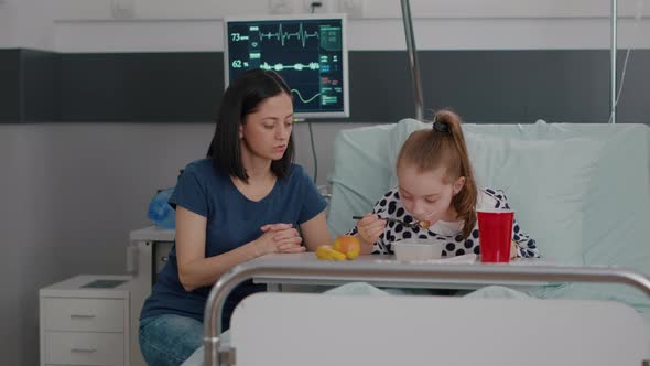 Mother Standing with Sick Daughter While Eating Healthy Food Meal During Lunch