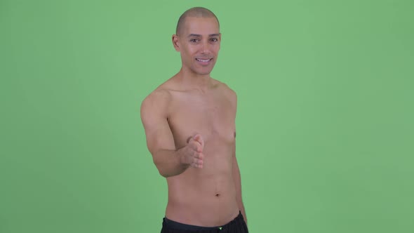 Happy Bald Multi Ethnic Shirtless Man Giving Handshake