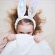 A Cute Little Girl with Bunny Ears is Lying in Bed and Hiding - VideoHive Item for Sale