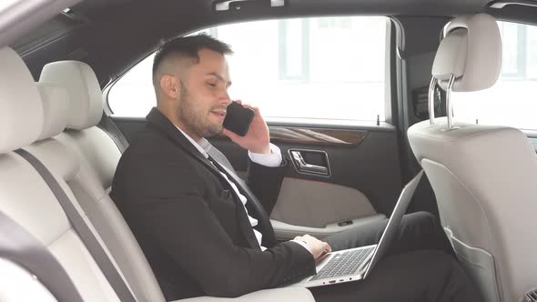 Elegant Young Man with Beard Talking on Phone, Process of Working in Car