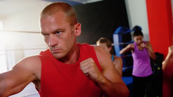 Boxers practicing in boxing ring