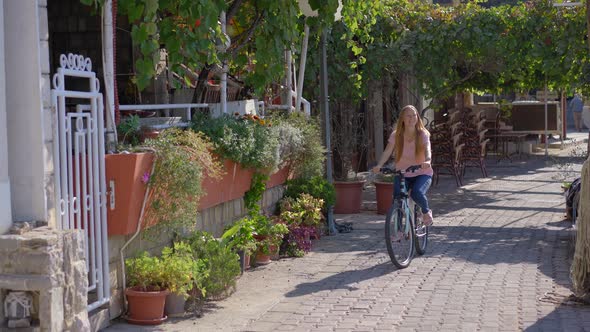 A Young Woman Rides a Bicycle in the City of Budva a Famous Tourist Place in Montenegro