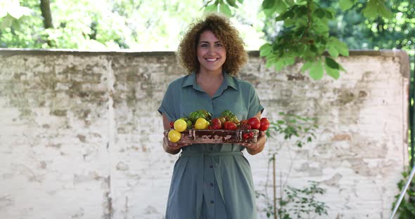 Woman with fresh vegetables in garden