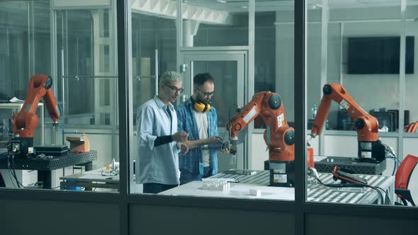 Robotics Engineers Are Observing a Bionic Arm in Motion alt