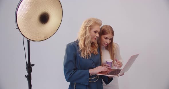 Model And Stylist Working On Laptop In Studio