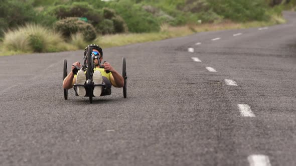 Disabled man riding a recumbent bicycle