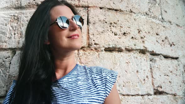 Travel Woman Posing at Antique Wall Admiring Architecture