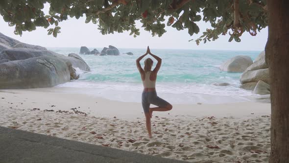 Young Woman Practices Yoga