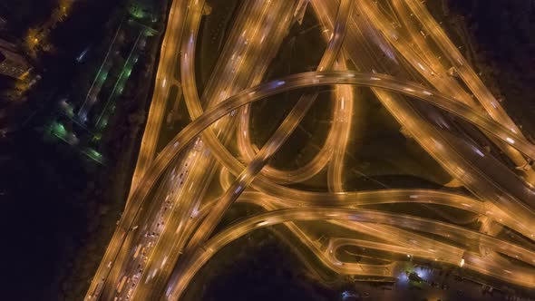 Road Junction and Cars Traffic at Night. Flyover. Aerial Top Down View