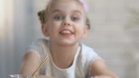 Cute Little Girl Suddenly Appearing Smiling Into Camera, Preparation for Matinee