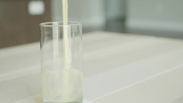 A Closeup Shot in Slow Motion of Juice Pouring From a Transparent Glass