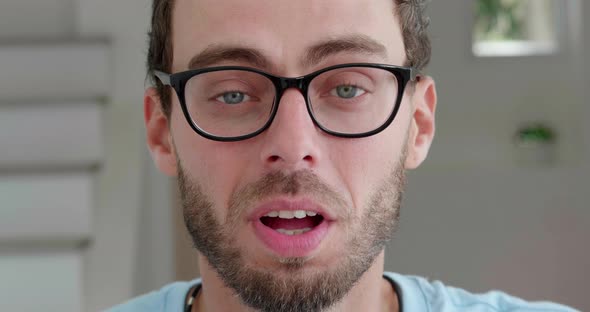 Soft Focus on Facial Expressions of an Attractive Young Caucasian Bearded Man Wearing Eyeglasses for