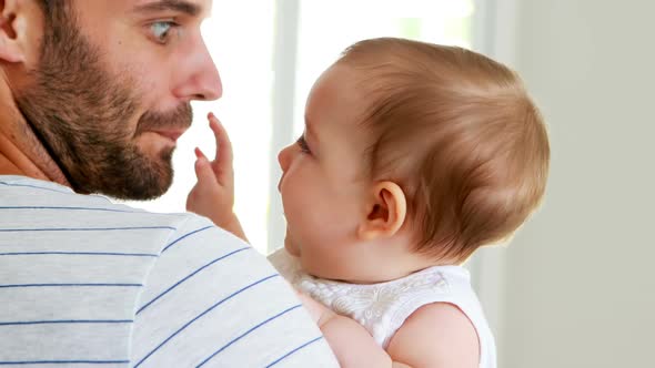 Father kissing his baby girl on forehead