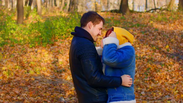 Happy Couple Embracing Outdoors in Autumn Forest