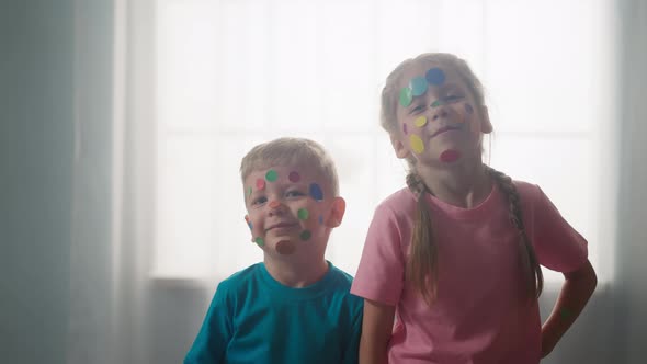 Little Brother and Sister with Polka Dot on Faces in Room