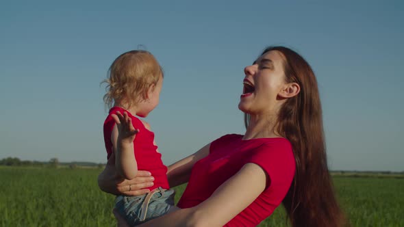 Mother with Baby Daughter Enjoying Leisure Outdoor