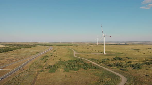 Windmills for Electric Power Production in the Meadow. Group of Windmills for Renewable Electric