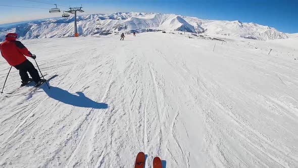 Skier Riding on Slope with Front Holding Camera