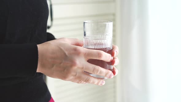 Hand with glass of water close up video 4k