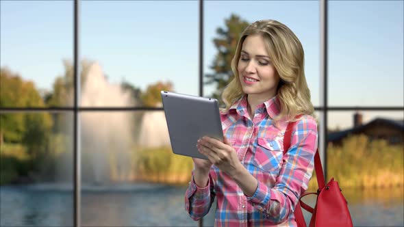 Attractive Young Woman Using Digital Tablet.