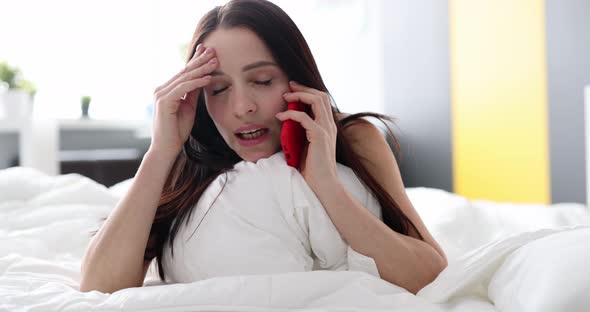 Crying Upset Woman Talking on Phone at Home