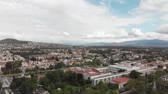 Drone view of a cloudy day, with blue sky, in Mexico City. Drone ascending slowly
