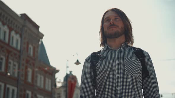 Stylish Male Tourist with Backpack Looking To Cityscape on the Embankment, Man on Vacation Outdoor