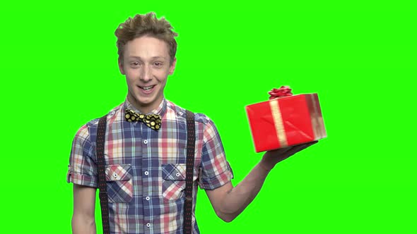 Young Teen Boy Presenting Gift Box