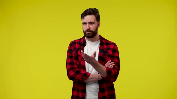 A Man Looking at the Camera Raising His Hand to His Chin Thinking About Something and Discussing His