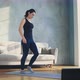 Stylish Woman Does Dynamic Lunges Watching Video on Laptop - VideoHive Item for Sale