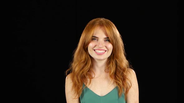 Girl Shows the Tongue and Winks. Black Background