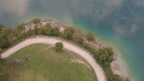 Masterpiece aerial shot of a unique and irresistible lake ledro with luxuriant environment