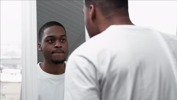 Male Skincare Happy African Man Looking in Mirror