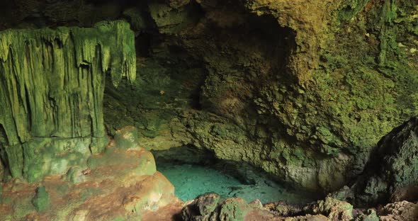 A Large Grotto That is Underground and Has a Lake with Clear Water