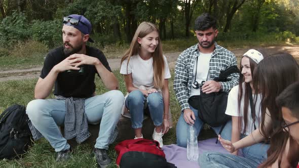 Circle of Friends Sitting in Forest and Talking