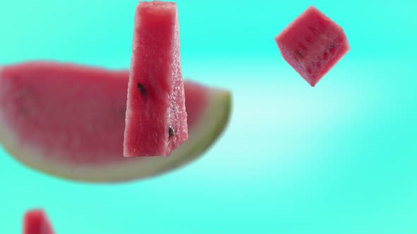 Flying of Watermelon and Slices in Turquoise Background