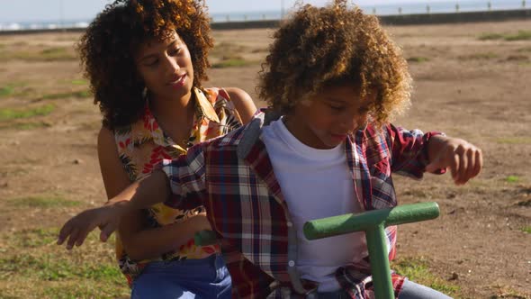 Mother and son having fun at playground