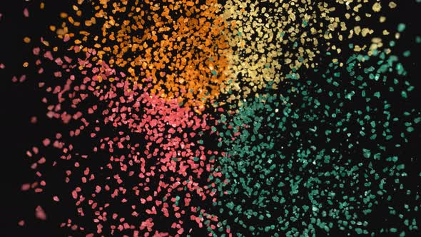 4K 30fps, Colorful particles fly after being exploded against black background, Slow Motion