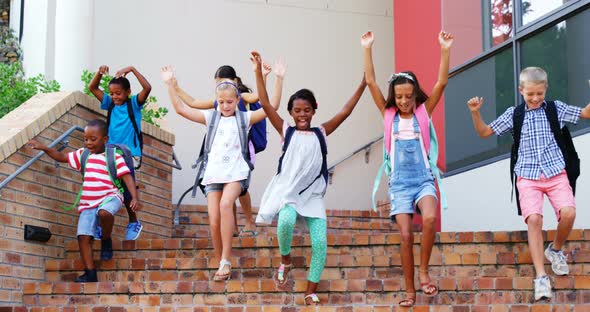 Group of kids getting down from staircase