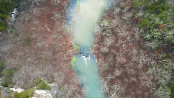 Blue Water River Flowing in Colorful Foliage Forest Landscape, Aerial
