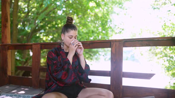 Slow Motion Shot of Woman Drinking From Tea Bowl