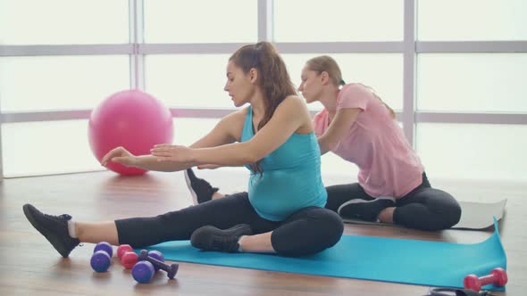 Young Pregnant Woman Doing Fitness Exercises in a Group Sports Class