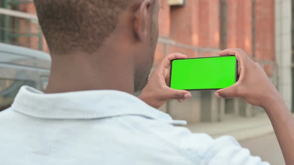 Outdoor African Man Holding Smartphone with Green Screen