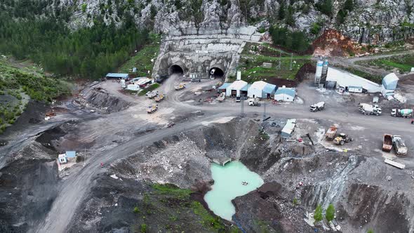 Heavy machinery drills tunnel through the mountain aerial view 4 K